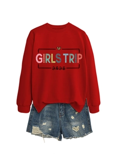 Detail of red Girls Trip 2026 sweatshirt paired with distressed denim shorts