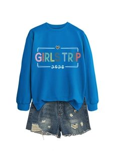 Close-up of blue Girls Trip 2026 sweatshirt with leopard heart and denim shorts