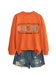 Detail of Girls Trip 2026 orange sweatshirt with leopard heart and ripped denim shorts