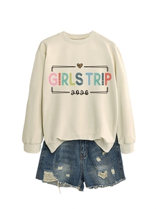 Detail view of beige Girls Trip 2026 sweatshirt with leopard heart and frayed denim shorts