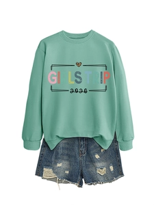 Detail of mint green sweatshirt with Girls Trip 2026 print and distressed denim shorts