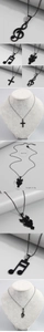 Detailed view of matte black cross, owl, and music note pendants on display stands