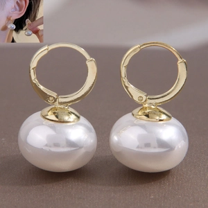 Elegant gold-plated hoop earrings with large white pearls for a minimalist style