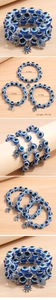 Detailed view of triple-layer blue evil eye beaded bracelet with hamsa hand charm