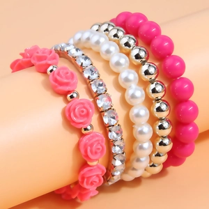 Five-piece stacked beaded bracelet set with pink resin flowers and sparkling crystals