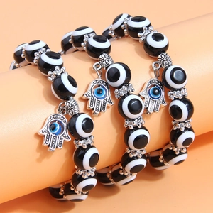 Three-layer bohemian beaded bracelet set featuring evil eye hamsa hand charms in silver