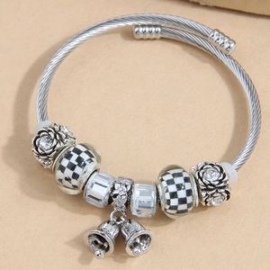 Silver twisted rope bangle with black checkered beads, floral crystals and small bells