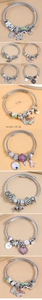 Dettaglio del bracciale a cavo d'argento con ciondoli a cuore in zircone e arcobaleno