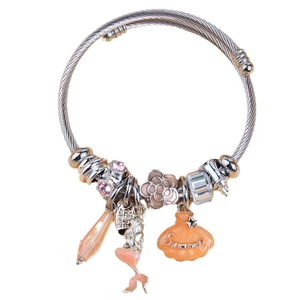 Adjustable mermaid and seashell charm bangle with pink crystals on a white background