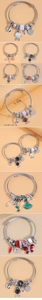 Detail of silver alloy wire bracelet featuring colorful fish and heart charms with gems