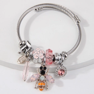 Silver twisted bangle with pink crystal bee charms and floral enamel pendants