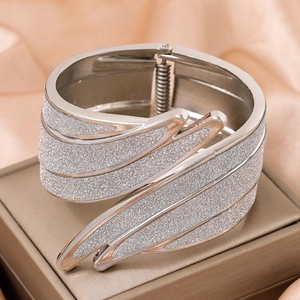 Silver angel wing metal cuff bracelet with frosted finish on luxury gift box