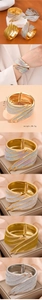 Detail shot of stylish wing shaped bangle with glitter coating and spring hinge closure