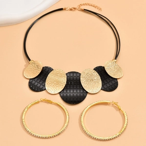 Macro view of gold hammered disc necklace and sparkling rhinestone hoop earrings