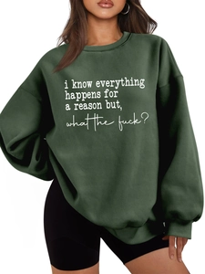 Detail of oversized dark green sweatshirt with white letter print and ribbed cuffs