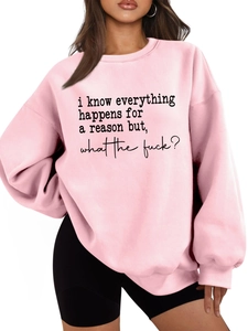 Detail of pink oversized sweatshirt showing slogan print and thick cotton texture