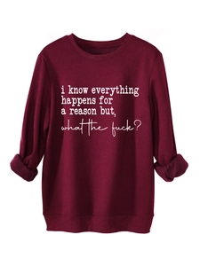 Detail of burgundy thick sweatshirt showing slogan print and fleece lining texture