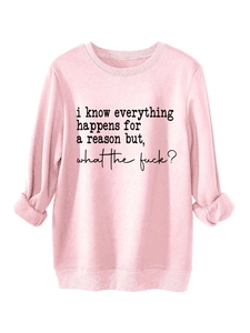 Close-up of pink crewneck sweatshirt featuring black text print and ribbed cuffs