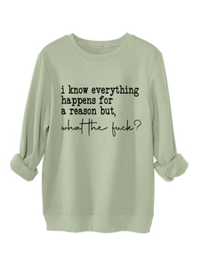Close-up of sage green sweatshirt featuring artistic black text print on fabric