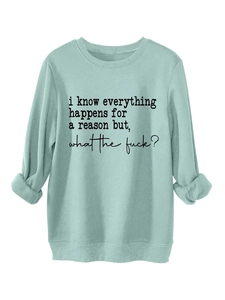 Detail of mint green thick crewneck sweatshirt with black slogan and ribbed cuffs
