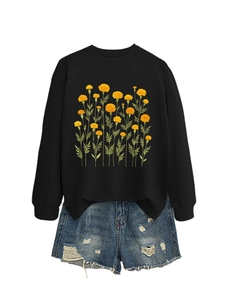 Vista piatta della felpa nera con stampa calendula gialla e pantaloncini di jeans sfrangiati