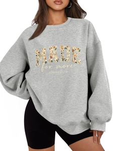 Detail of grey oversized sweatshirt with floral MADE for more and EPHESIANS text