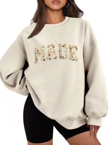 Detail of oversized cream sweatshirt with floral MADE lettering and Ephesians print