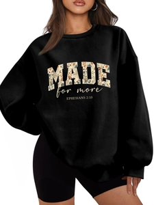 Detail of floral font on black oversized sweatshirt with Ephesians 2:10 printed quote