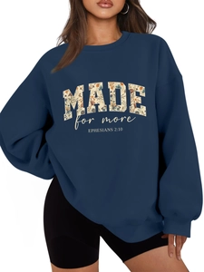 Detail of floral printed MADE FOR MORE text on navy blue oversized sweatshirt