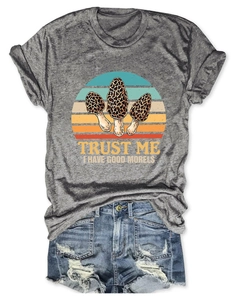 Flat lay of heather gray t-shirt with funny mushroom print and distressed denim shorts