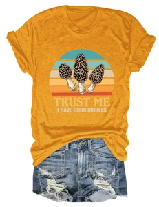 Detailed flat lay of mustard yellow t-shirt with mushroom print and denim shorts