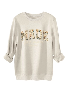 Close-up of beige crewneck sweatshirt with floral MADE print and Ephesians text detail