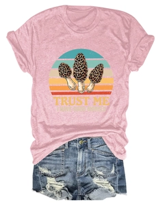 Close-up of pink crew neck T-shirt with 'Trust Me I Have Good Morels' mushroom graphic print
