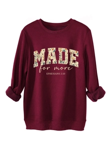 Close-up of burgundy sweatshirt showing floral filled MADE text and ribbing details