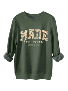 Detail of dark green sweatshirt showing floral MADE lettering and soft fleece lining