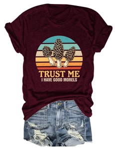 Detail of burgundy cotton t-shirt with mushroom graphic and ripped denim shorts