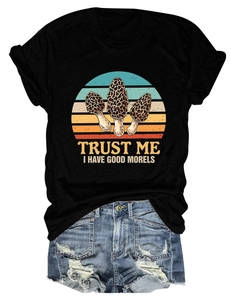 Detailed flat lay of black cotton t-shirt with mushroom print and ripped denim shorts