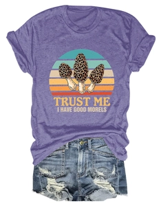Flat lay of purple T-shirt with Trust Me I Have Good Morels print and ripped denim shorts