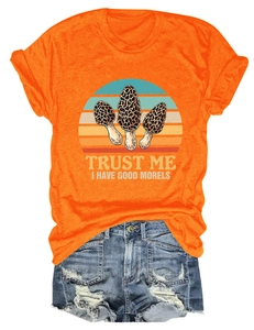 Detail of the high-quality print 'TRUST ME I HAVE GOOD MORELS' on an orange cotton T-shirt