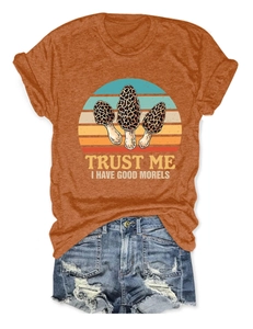 Detail of orange cotton t-shirt with mushroom print and distressed denim shorts