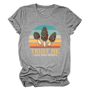 Detail of dark grey t-shirt featuring vintage mushroom graphic and retro sunset design