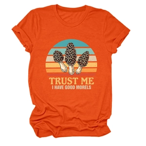 Detailed view of an orange cotton T-shirt featuring a retro sunset mushroom print graphic