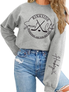 Close-up of Rinkside Social Club vintage circular logo and text on grey hooded sweatshirt
