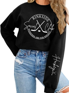 Detail of Rinkside Social Club print on a black crewneck sweatshirt with hockey graphics