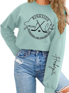 Detail of mint green hoodie with Rinkside Social Club logo and hockey cuff embroidery