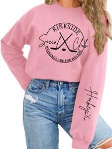 Pink hockey sweatshirt detail featuring black Rinkside Social Club graphic and sleeve print