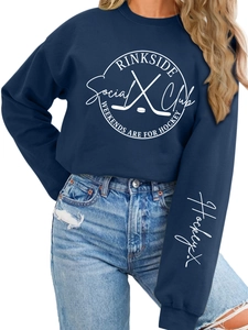 Detail of Rinkside Social Club navy sweatshirt with hockey graphics and sleeve embroidery