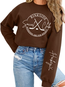 Detailed view of Rinkside Social Club print on warm brown fleece sweatshirt for women