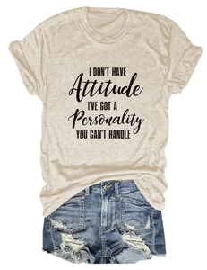 Detailed flat lay of beige t-shirt with gothic slogan and distressed denim shorts