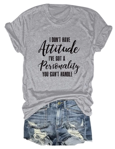 Flat lay of gray t-shirt with slogan paired with distressed blue denim shorts